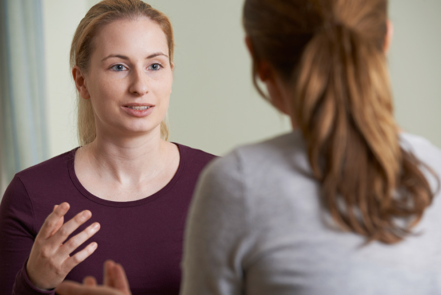 A social worker talks to a client.